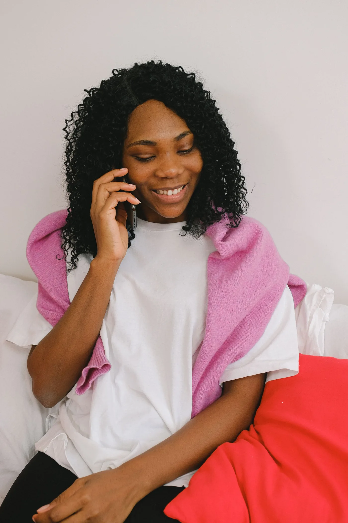 A woman enjoying a conversation by phone at home