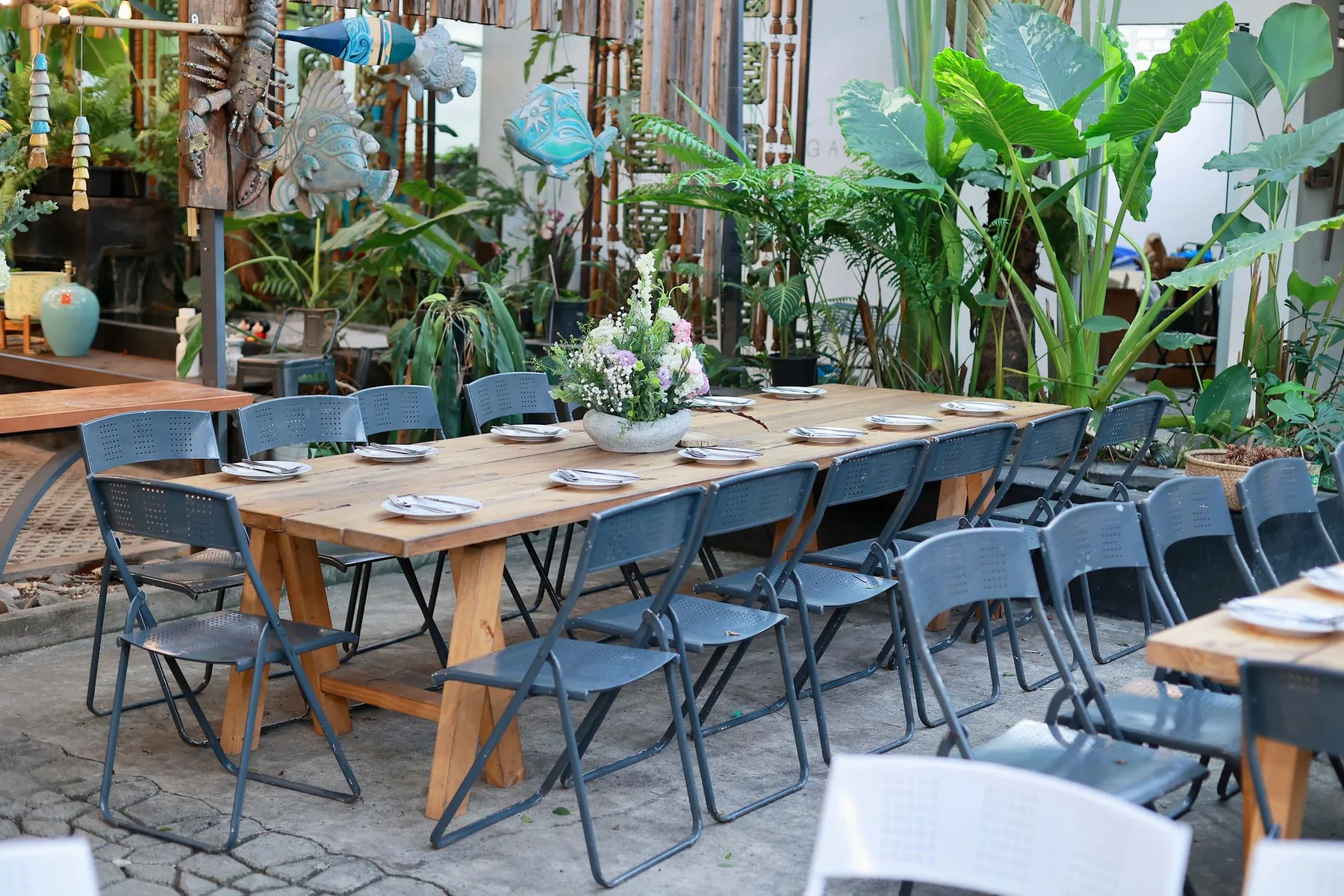 An inviting garden dining space surrounded by greenery