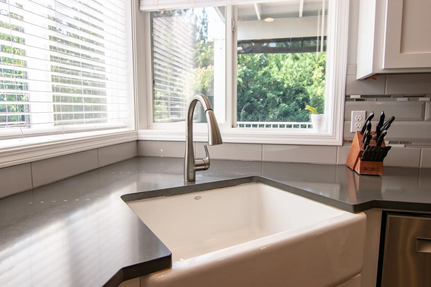 A kitchen sink beside a bright window